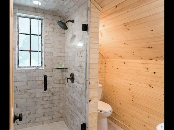 Bathroom with shower, toilet and sink.
