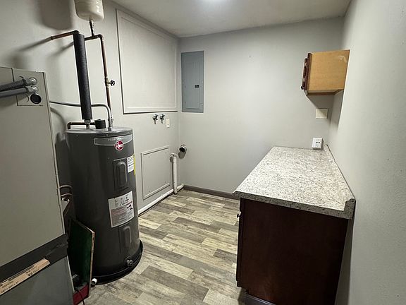 walk in laundry/utility room with cabinets for storage and counter for laundry