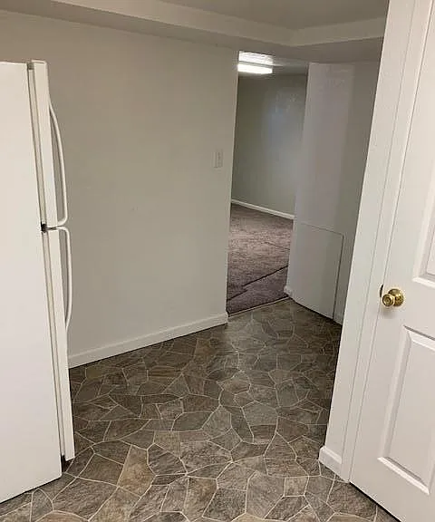 kitchenette showing nook area, refrigerator and bathroom door
