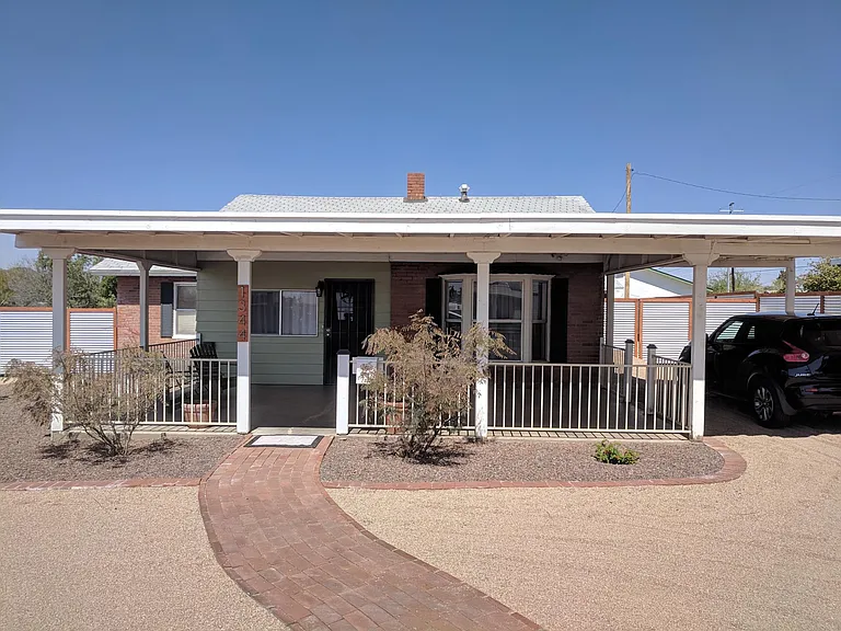 One covered spot, plenty of additional parking. Gravel driveway.