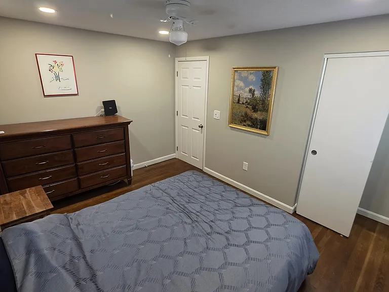 2nd bedroom with queen adjustable bed, mini split and dresser.