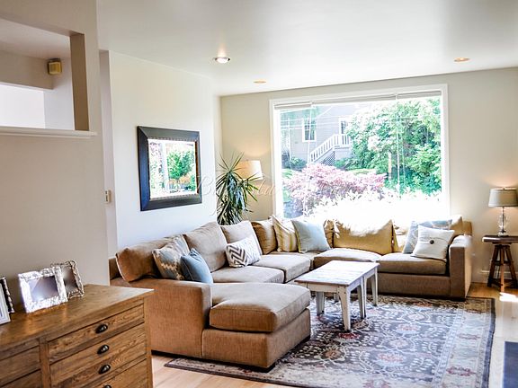 Sun-filled living room open to dining room