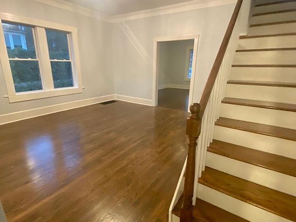 dining room with stair case and view towards front
