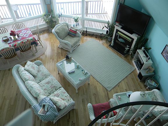 Living room with cathedral ceiling
						:
						Hickory flooring, gas fireplace, huge custom windows, spiral staircase