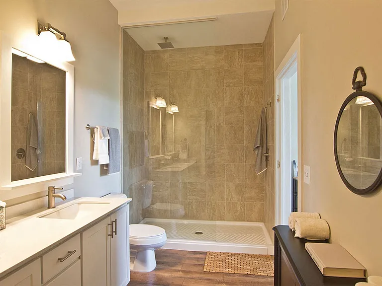 Over-sized, 6' glass walk-in shower with marble surround and rain-shower