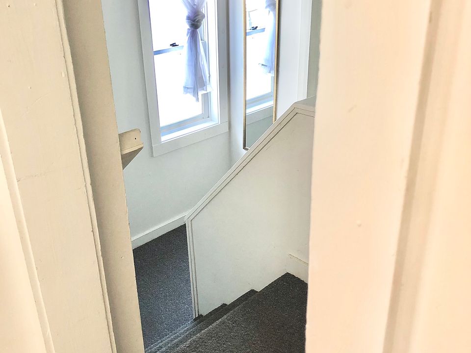 Stairs from kitchen landing down to hall