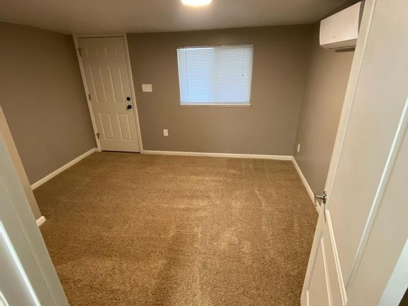Floors are now hard surface tile plank in bedroom. Has a queen-sized bed, night stand, dresser and mirror.