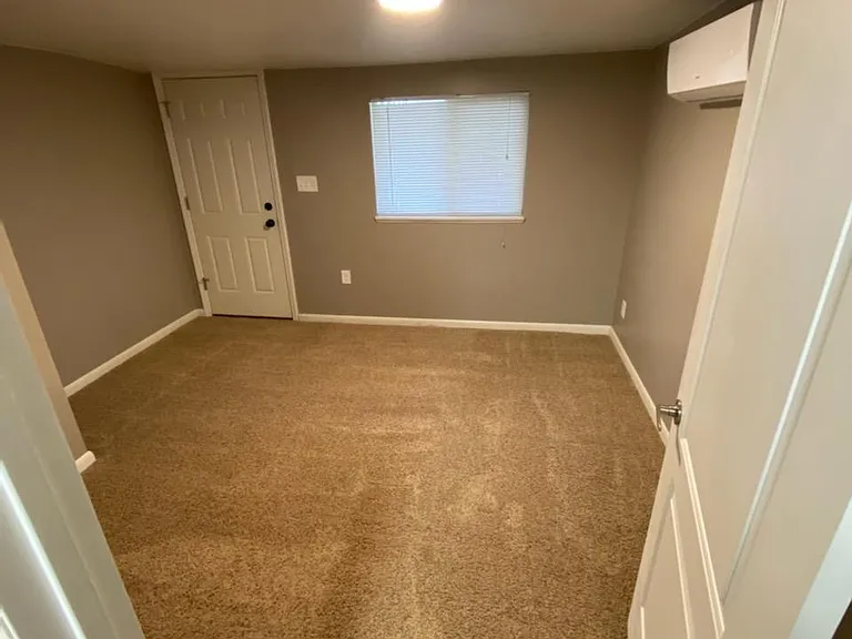 Floors are now hard surface tile plank in bedroom. Has a queen-sized bed, night stand, dresser and mirror.