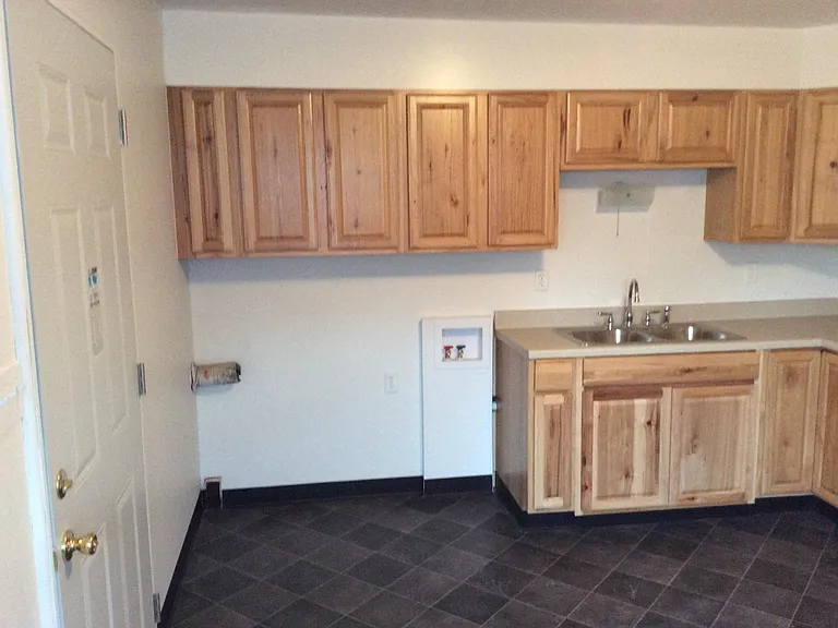 Kitchen with new floor, sink, counter top, some new cabinets