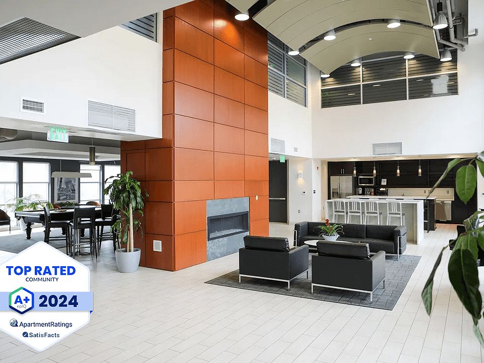 Metro Crossing Apartments Clubhouse Interior with Resident Satisfaction Logo Banner