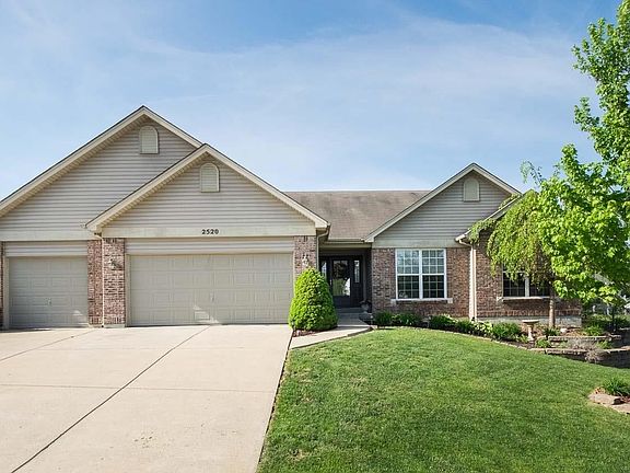 LARGE 3 CAR GARAGE, COVERED FRONT PORCH AND PRETTY ELEVATION WITH BRICK AND VINYL.
