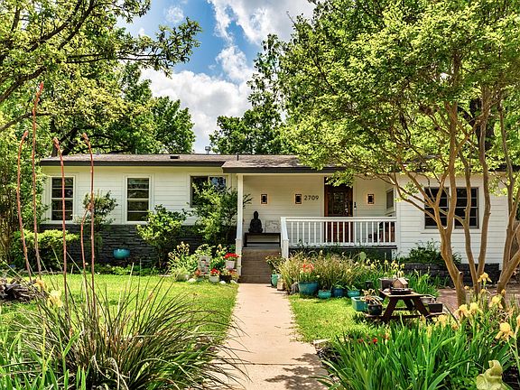 Welcome home. Crisp, fresh, modern exterior with lush landscaping.