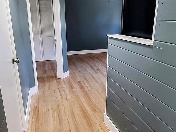 Walkway into kitchen (on right) and bedroom