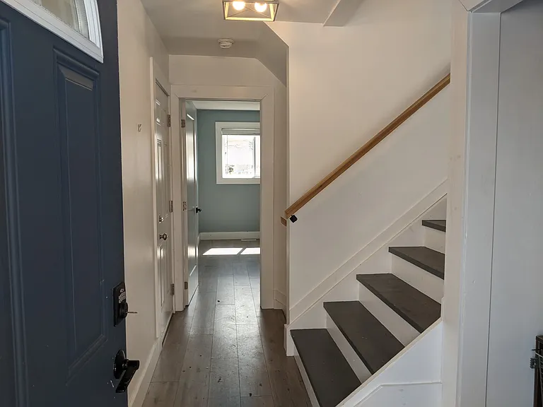 Entrance door showing stairs up to the living room on the right and 4th Bedroom/Office is straight ahead.