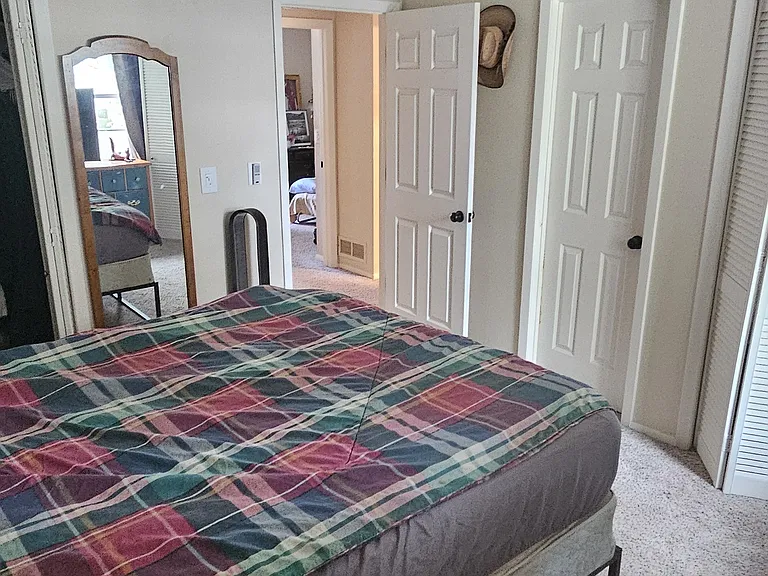 Master bedroom, 2 closets, and door walkthrough to master bathroom