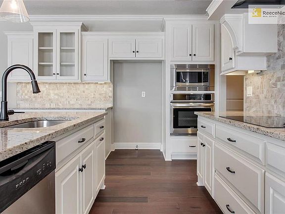 Timeless white cabinets line the walls of this beautiful kitchen.