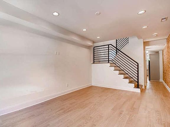 Open living room through to kitchen and dining. Recessed lig