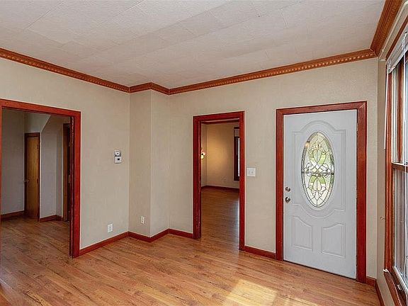Looking from back of the main living room towards the two bedrooms and front entrance door.