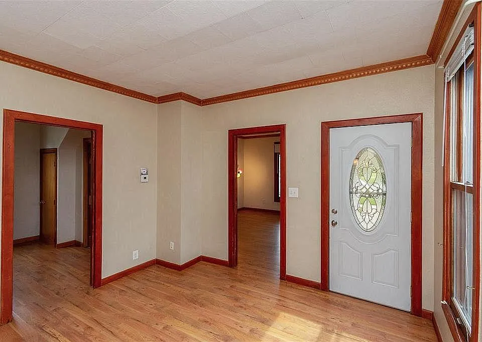 Looking from back of the main living room towards the two bedrooms and front entrance door.