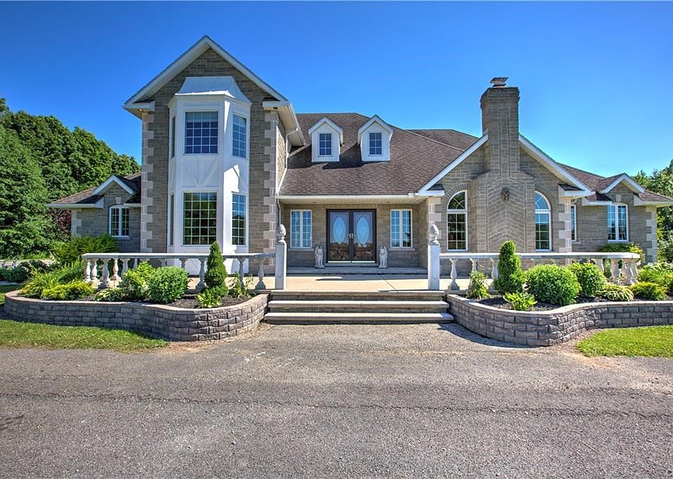 Citadel Stone surrounds this Unique Property, Double Front doors boasts the Dramatic Entryway. Sprawling Gardens and Lavish Landscaping all make this home one of the most Desirable Homes in CNY