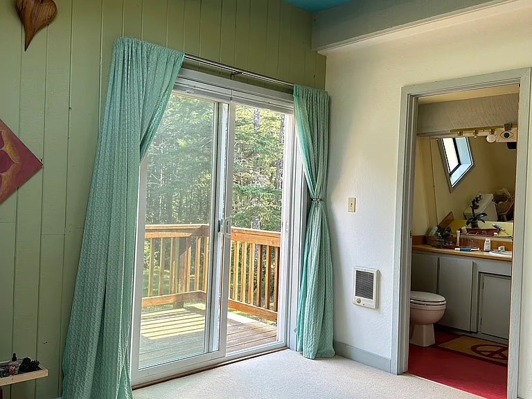 Upstairs bedroom with queen bed, deck and full bath
