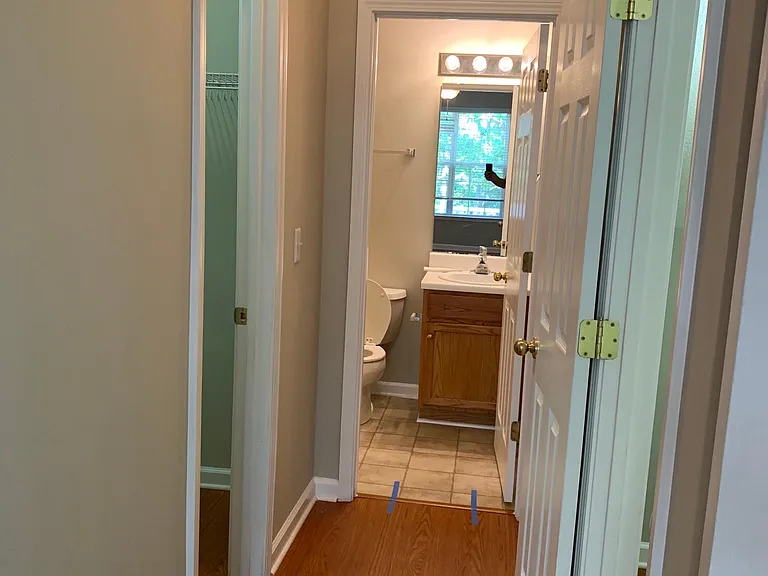 hallway in master bedroom to bath with his and hers closets on each side
