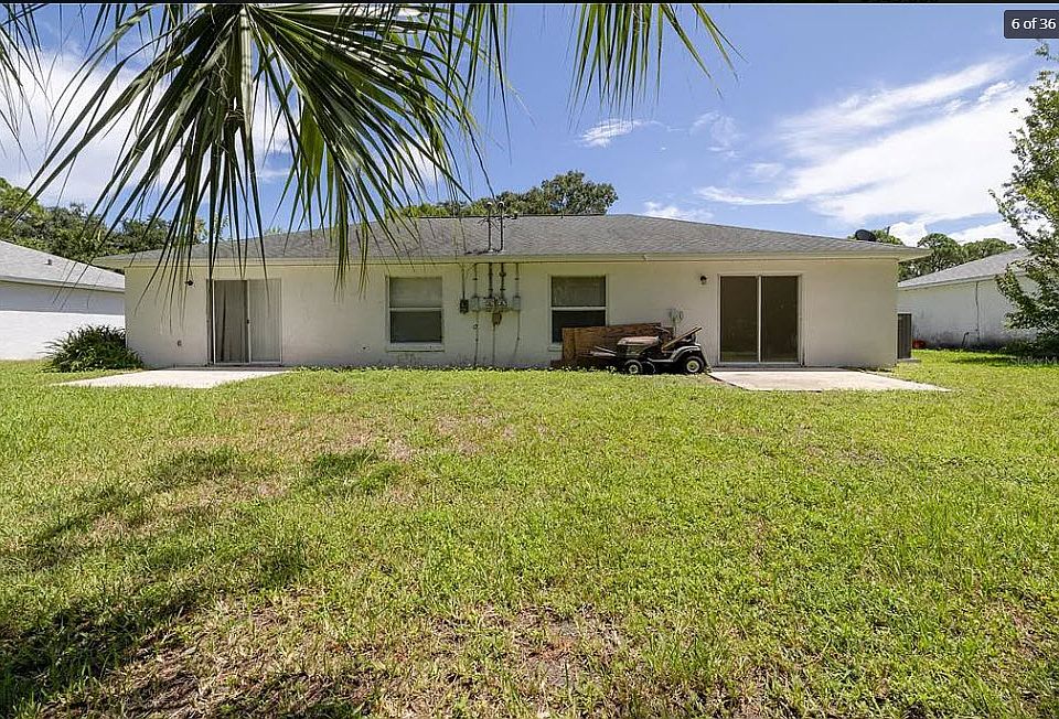 Open backyard and separate concrete patios with sliding door access