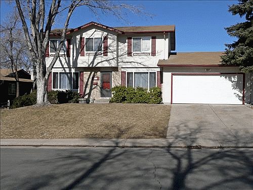 Entry with clock sprinkled yard