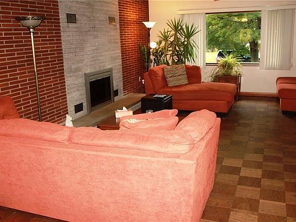 Spacious living room with picture window and fireplace.