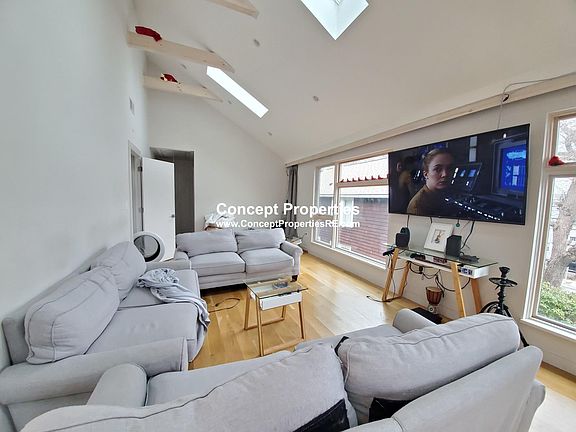 Open living room area with skylights