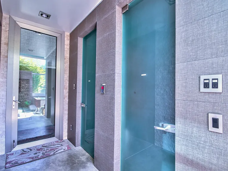 steam room and sauna area with bathroom