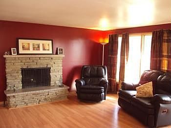 The living room has a fireplace and newer laminate flooring.