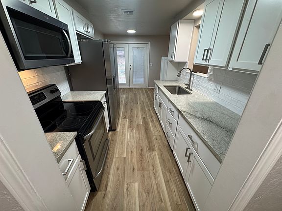 new cabinets and granite countertops in kitchen