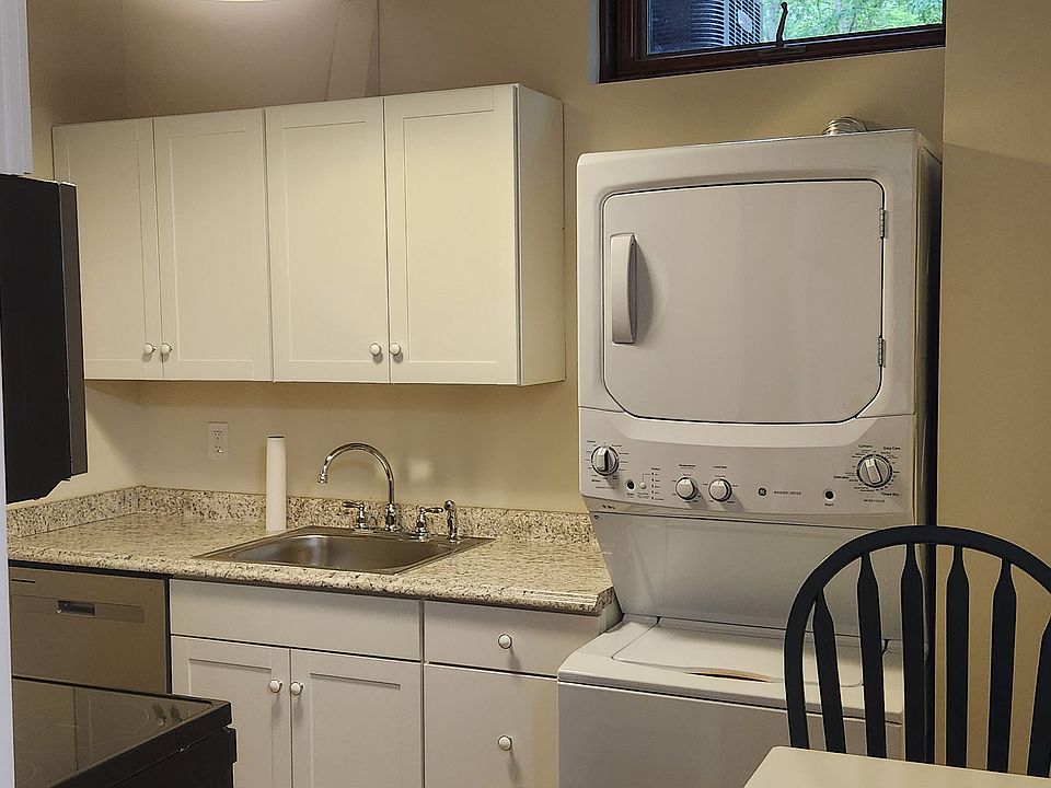 Brand new kitchen with stackable washer and dryer with fold up table.