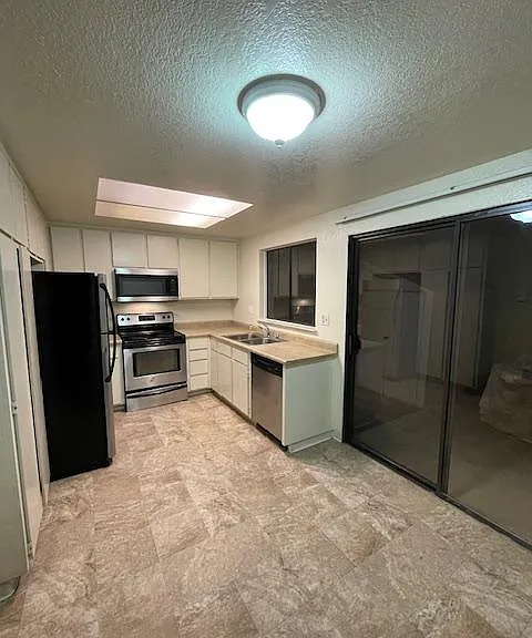 Kitchen has sliding glass doors that opens to private back patio.