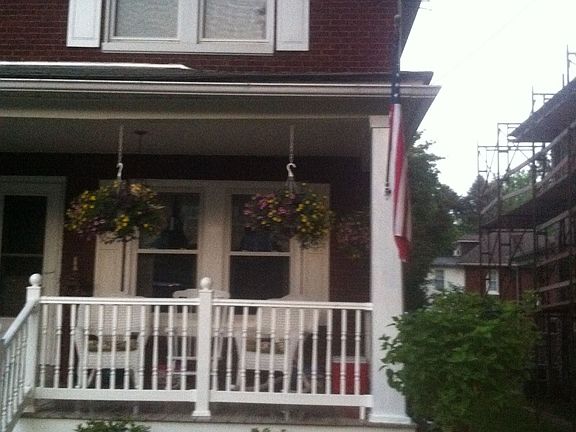 Front of house with new vinyl railings, shutters and flowerbed