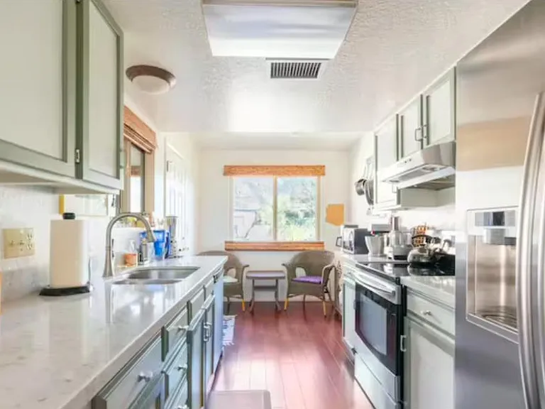 Fully-equipped kitchen with a breakfast nook overlooking the mountains -- perfect for morning coffee (and the coffee maker is right there!)