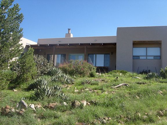 South side of house : The covered porch and View windows enjoy a warm Southern exposure.