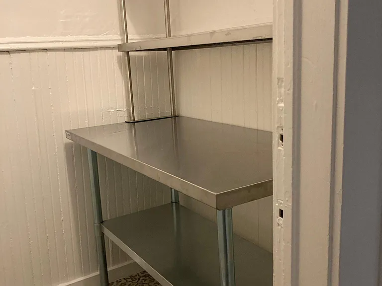 Pantry off kitchen with commercial stainless steel storage