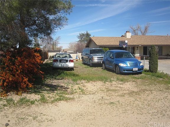 Additional dirt parking next to the driveway. Large enough to hold a big rig