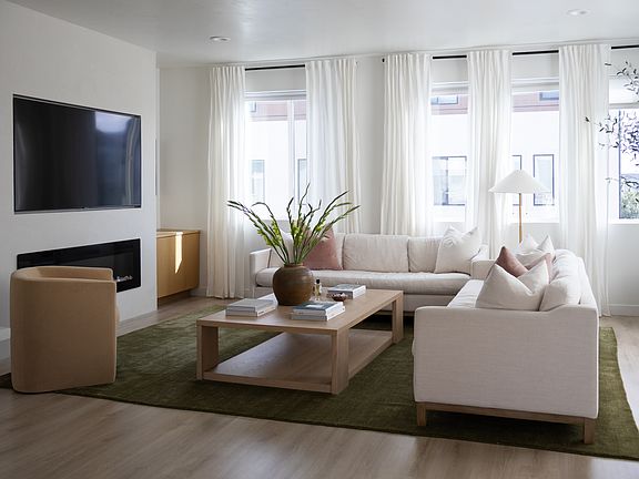 living room with electric fireplace and built in oak cabinets