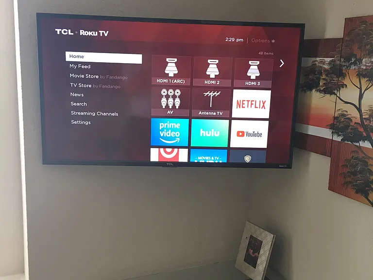 Roku TV in Bedroom 2 with Queen bed and desk.