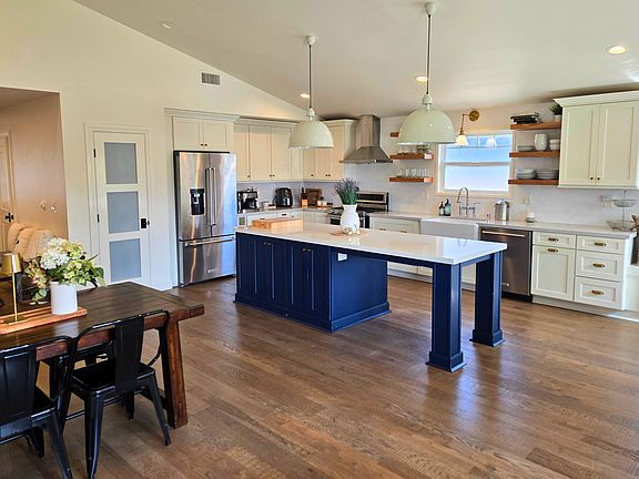 Spacious open concept kitchen with hardwood floors, center island, and premium KitchenAid appliances_perfect for a family living in Torrance.