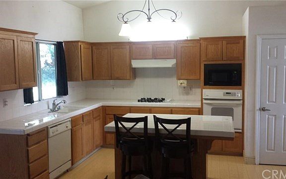 Kitchen with pantry and gas stove.