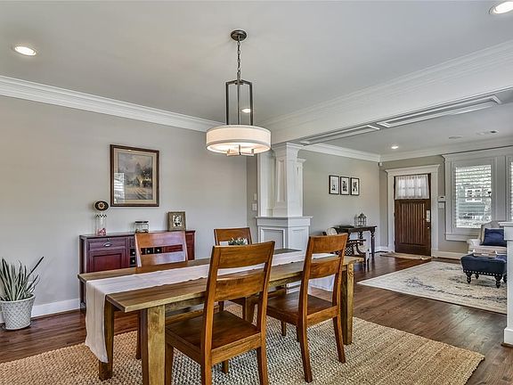 Another view of the dining room with a perspective into the formal living area. This view provides another look at the custom millwork completed throughout the home.