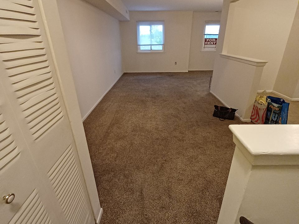 View from top of stairs showing Dining area and part of living room. Kitchen is on the right