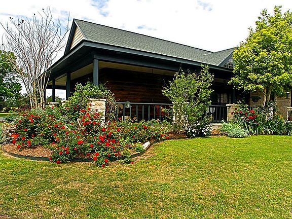 The bright colorful landscaping provides a curb appeal most desire. The thick green grass surrounds the house and improvements making this outdoor area enjoyable.