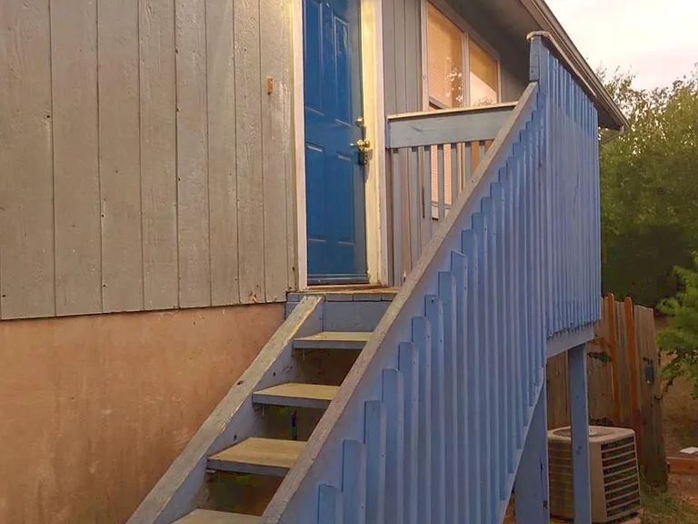 Front entry door is on the right. Air conditioner was replaced in August 2020, after this photo