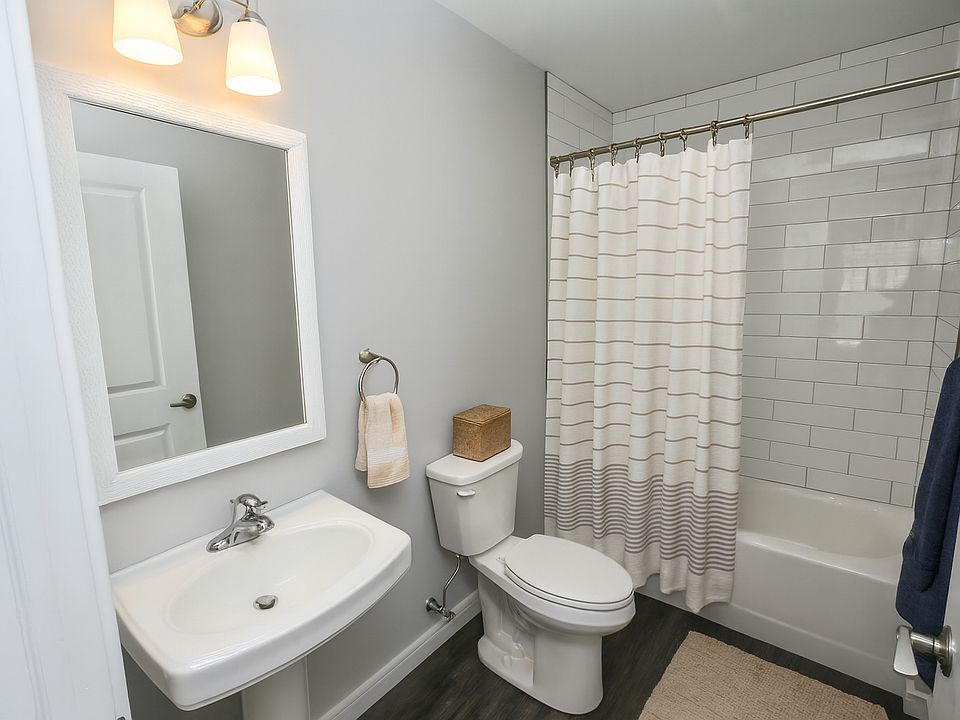 Full bathrooms with tiled tub surrounds.