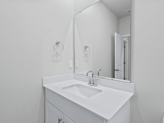 A full bathroom is located next to the first floor bedroom.